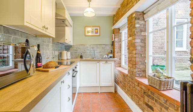 A charming, thoughtfully renovated cottage within the 17th century Papist Hall.