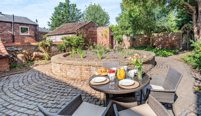 A charming, thoughtfully renovated cottage within the 17th century Papist Hall.