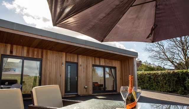 A contemporary cedar clad lodge adjacent to a national cycle route