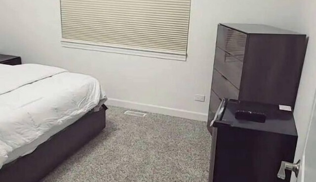 A cozy bedroom in a home with high-tech amenities