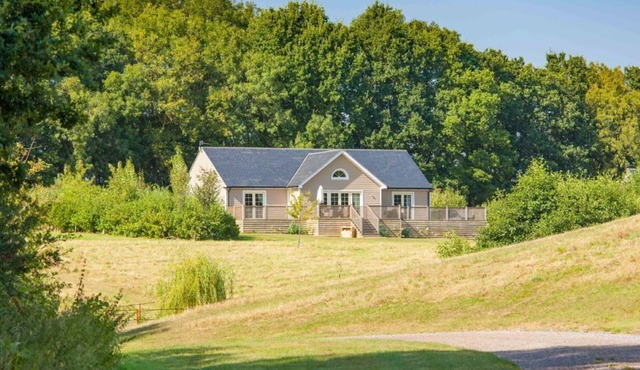 A delightful lodge with hot tub on Wakes Hall Farm is a haven of peace in 500 acres of private land