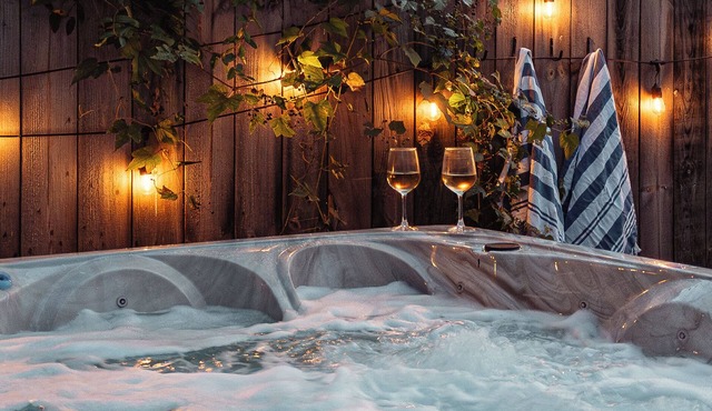 A designer forest retreat near Asheville—hot tub under the trees, fire pit nights, artisan coffee bar mornings, and luxe comfort in the Land of the Sky.