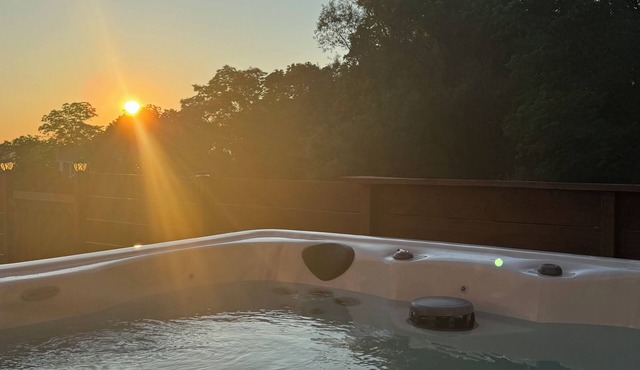 A dreamy Seneca Lake retreat with sweeping views, a relaxing hot tub under the stars, flexible bedroom setups, a fully stocked kitchen, cozy living spaces, and easy access to the lake, wineries, and waterfalls.