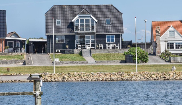 A few meters from the harbor quay and in the middle of the idyllic fishing village of Thorsminde lie