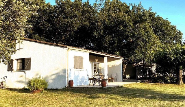 A house among the oaks with a swimming pool.