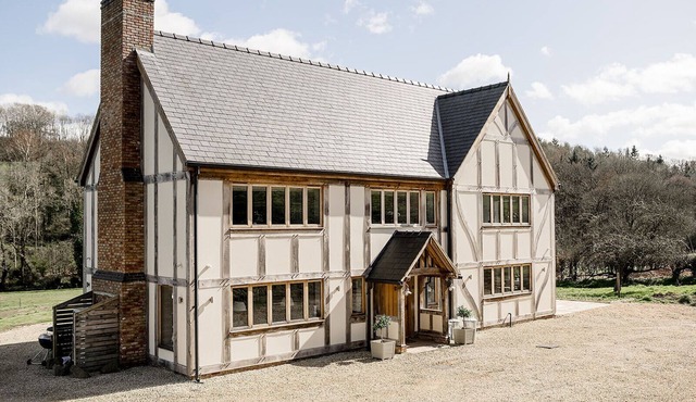 A luxurious riverside cottage with stunning views, a hot tub, and fishing access.