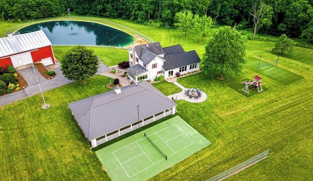 A luxury farm stay with something special for everyone in your group! Volleyball, baseball, pickleball, outdoor kitchen with pavilion, a private pond and dock for swimming, and so much more!
