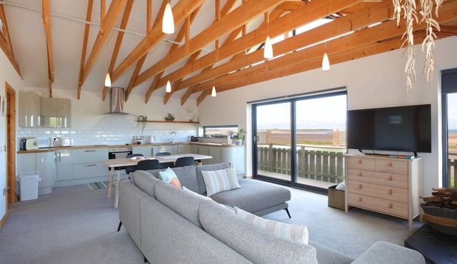 A modern, seafront chalet offering stunning beach views of Belhaven Bay.