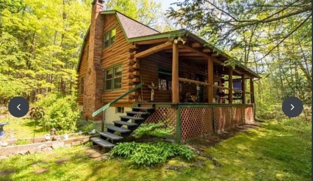 A modern "State of the Art" Log Cabin nestled in a serene wooded property.