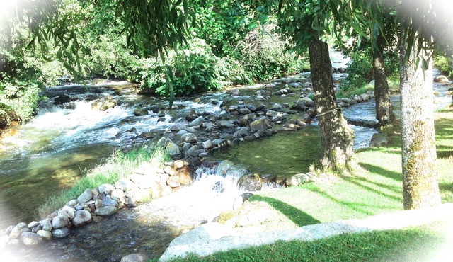 A mountain house nestling on the banks of a river *