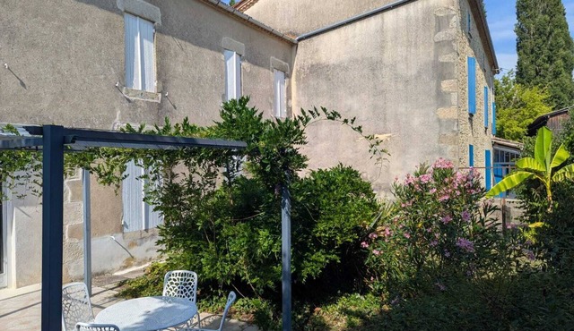 A peaceful interlude in a lush, flower-filled garden.