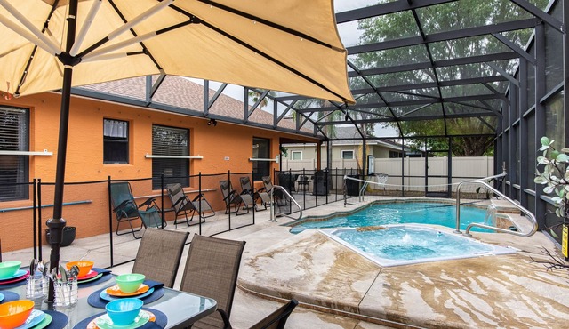A peaceful tropical oasis with a large saltwater pool and spa hot tub.