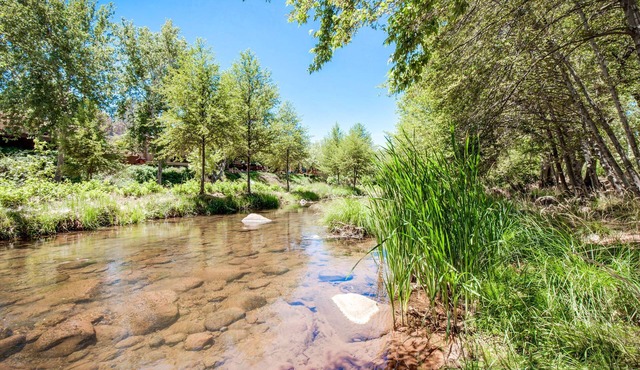 A river runs through. Private Estate on OAK CREEK! Pickleball Court in backyard!