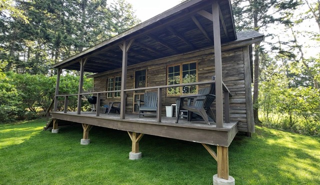 A rustic Maine log cabin with water access.