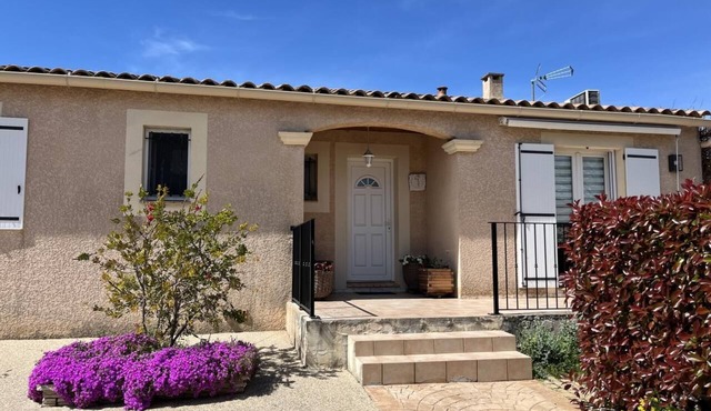 A single-storey house in a quiet subdivision with swimming pool and parking.