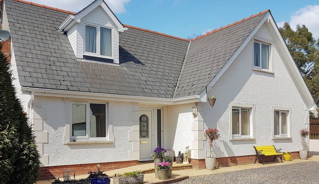 A spacious holiday home with a heavenly hot tub close to stunning beaches.
