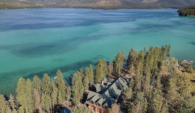 A stunning Montana log retreat on 50 secluded acres on Ashley Lake-perfect for large groups, featuring rustic luxury, expansive spaces, and room for up to 14 guests.