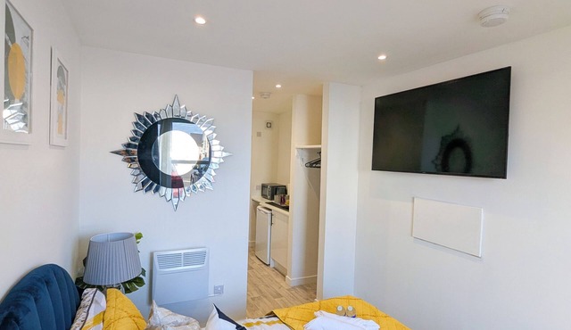 A stylish modern studio stay near attractions with comfy room and vibrant design
