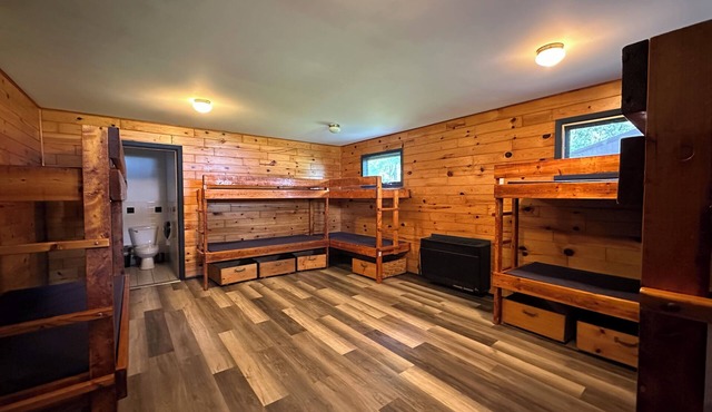 A summer camp cabin with attached bath and lounge area