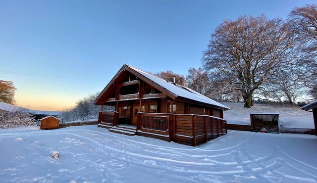 A traditional Scandinavian style lodge, with stylish wooden interior decorated with a Scottish theme