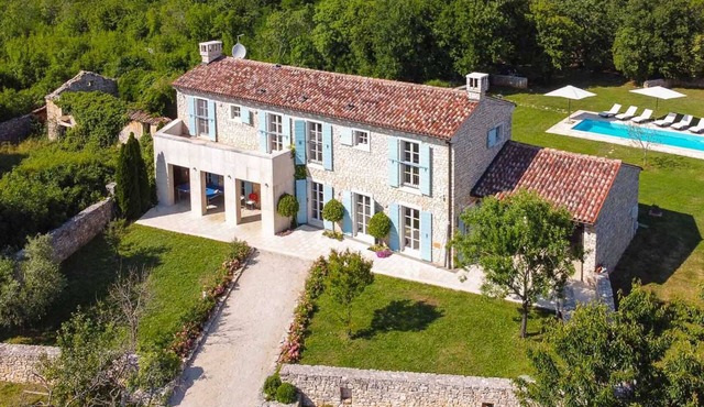 A traditional, stone villa in Marčana with a pool and children's playground
