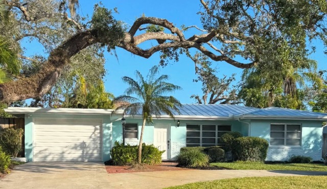 A tropical retro bungalow secluded area with terrazzo flooring & heated pool.