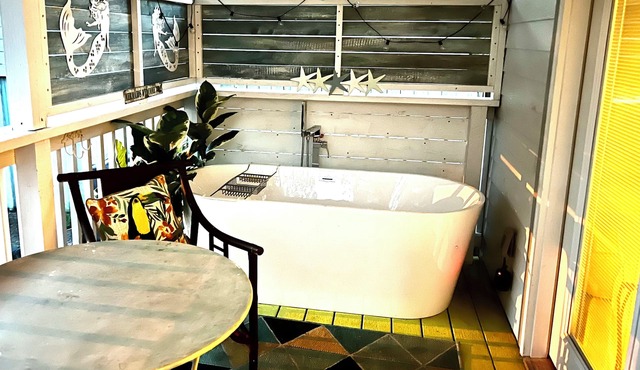 After beach time come back to an outdoor soaking tub in privacy fenced back yard