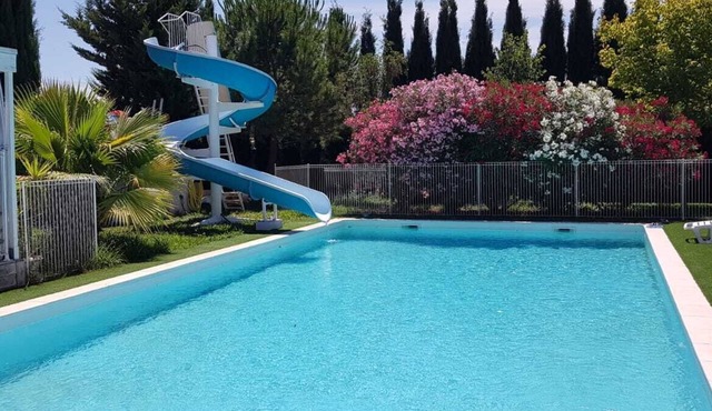 Air-conditioned 2-bedroom chalet with pool, slide, garden, games.