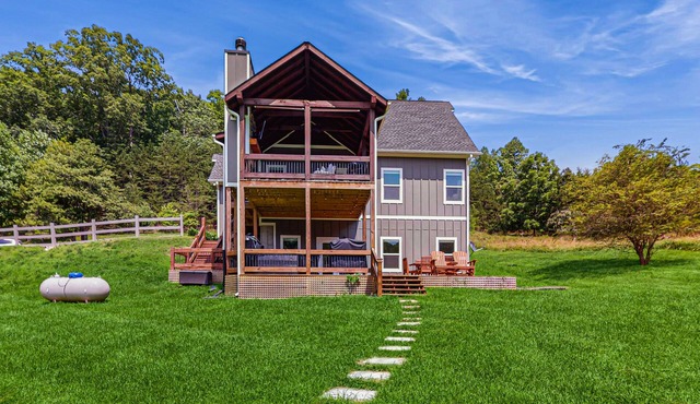 All-new creekside home in a gated community with spacious decks, yard, & firepit