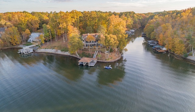 AMAZING PANORAMIC LAKE GASTON VIEWS IN THIS EXECUTIVE 6 BEDROOM HOME