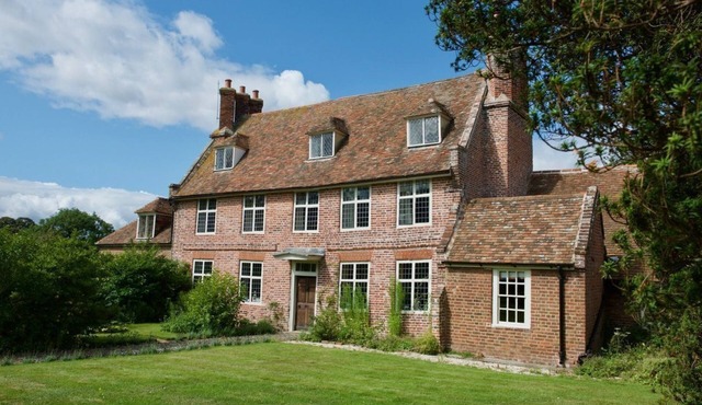 An exquisite Tudor Farmhouse lovingly restored with 7 bedrooms, 6 bath/shower, sleeping 14 in beauti