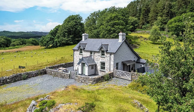 An impressive, detached stone-built cottage set within Gwydir Forest.