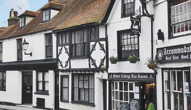 An unusual two-storey apartment with beams and an open fire.