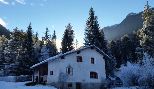 Ancient typical Engadine mill on a stream near the woods and walks