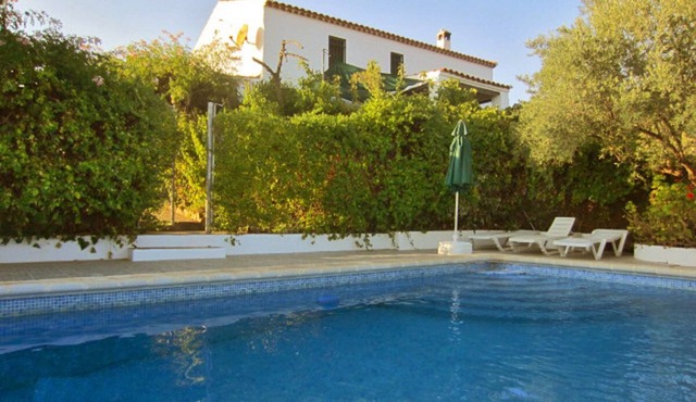 Andalusian traditional country house with pool, surrounded by olive groves
