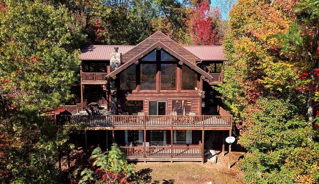 Antler Ridge - a stunning log cabin with spacious deck equipped with outdoor fireplace, hot tub, and scenic mountain views!