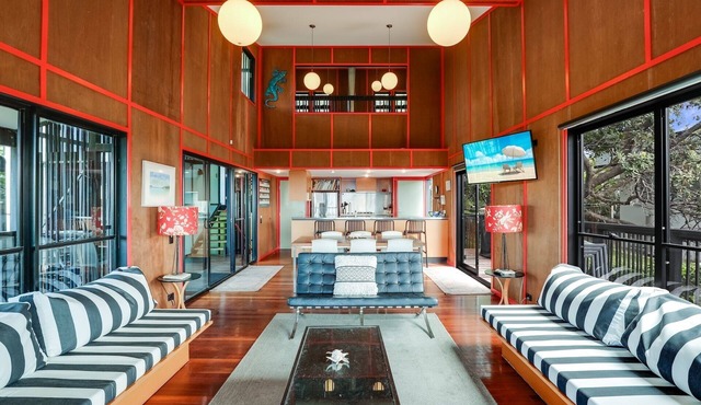 Architect designed family beach house perched high on a hill with water.