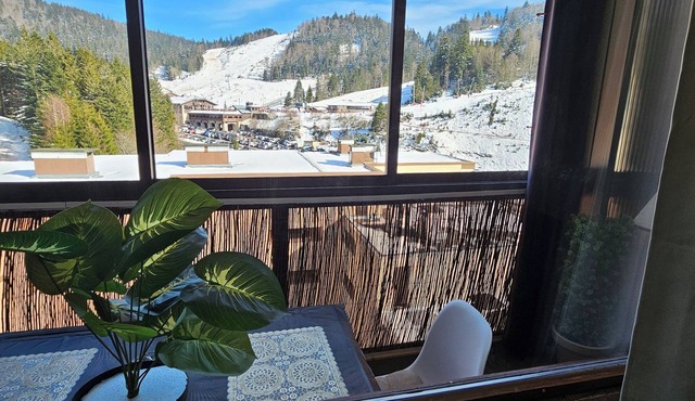 At the foot of the ski resort with a view of the slopes