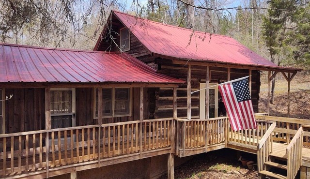 Authentic log cabin nestled in the woods by creek