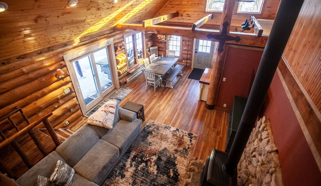 Authentic log cabin with cozy fireplace nestled in the woods