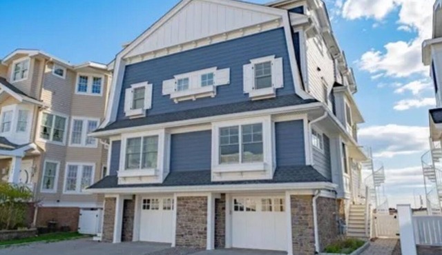 Avalon sunsets on the bay in this beautiful five-bedroom waterfront townhome.