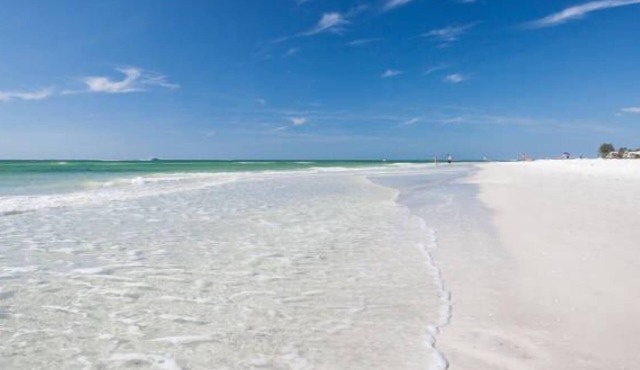 Beachy villa on Siesta Key with heated pool, screened in lanai, and ground level