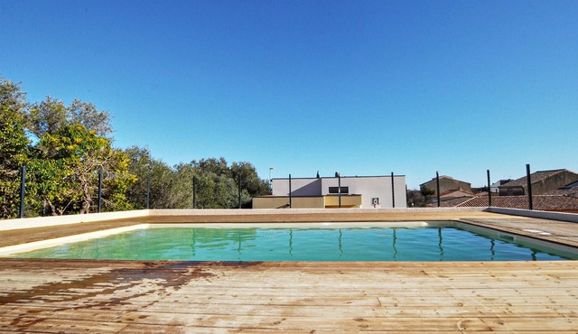 Beautiful and modern vacation home with communal pool and sea view from the terrace.