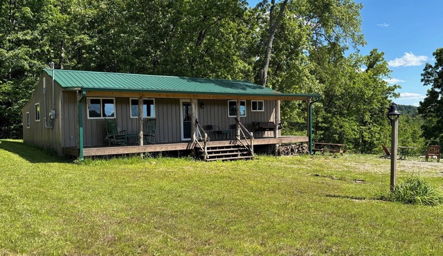 Beautiful Cabin Nestled in a Peaceful Wooded Setting with a Scenic Pond.