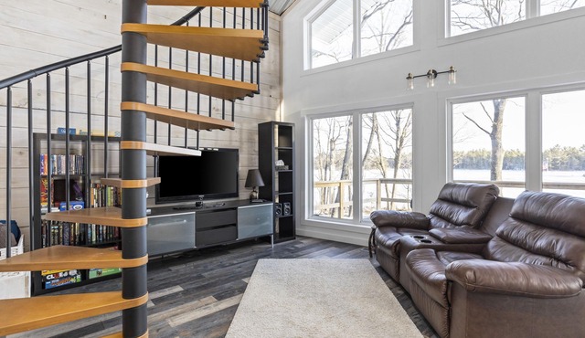 Beautiful cottage on the lake with brand new sauna, large yard and office space.
