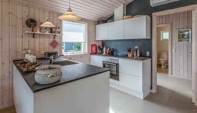 Beautiful cottage with kitchen open connection with dining and living room with an alcove.