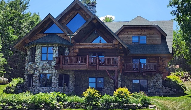 Beautiful handmade log home on private sand beach at the end of Big Bay