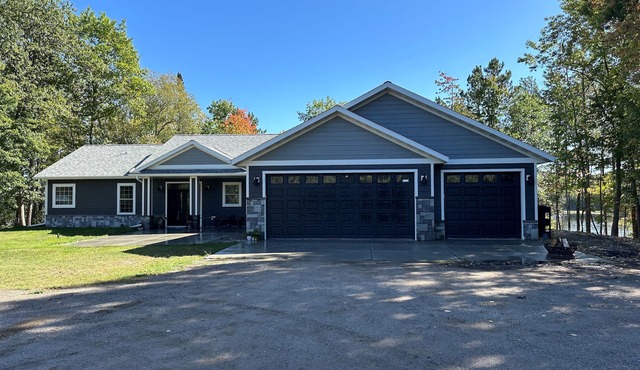 BEAUTIFUL lake front home with a private beach, dock and large yard