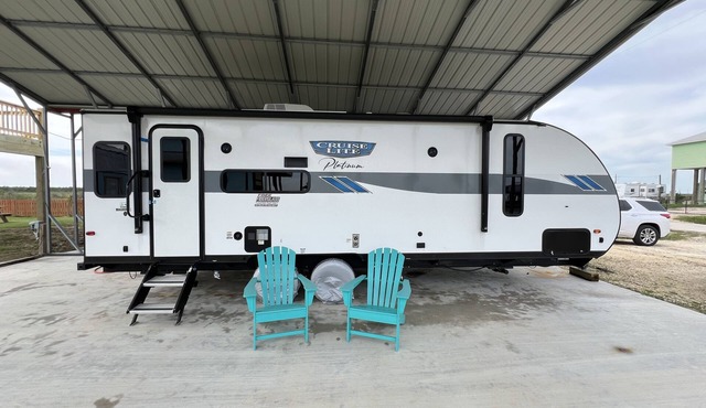 Beautiful NEW 2023 camper covered on concrete slab. Sit and enjoy the barges
