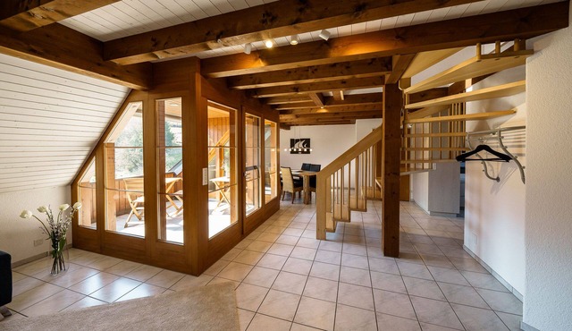 Beautiful penthouse duplex apartment with balcony surrounded by greenery